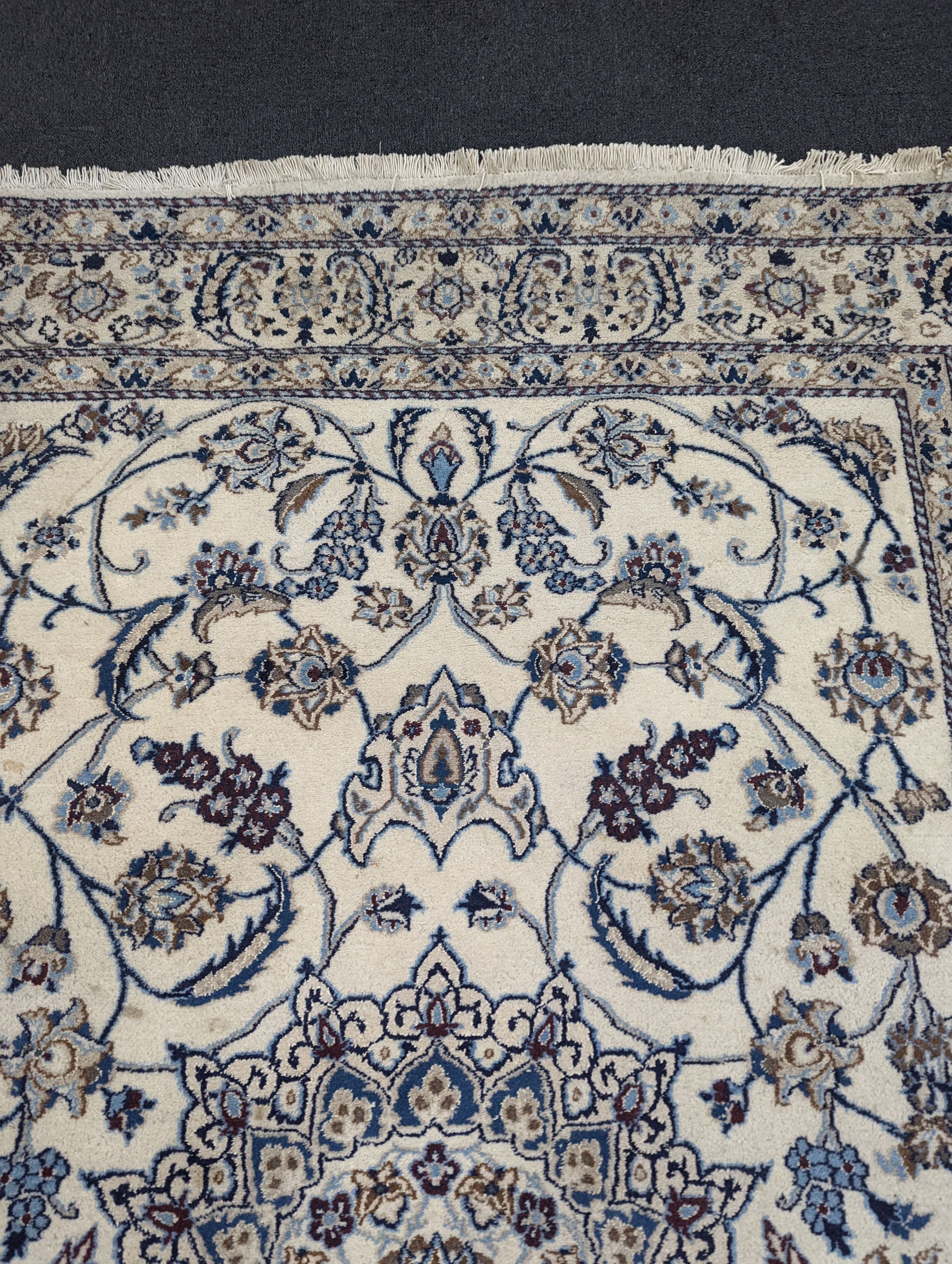 An ivory ground Nain carpet, 290 x 205cm